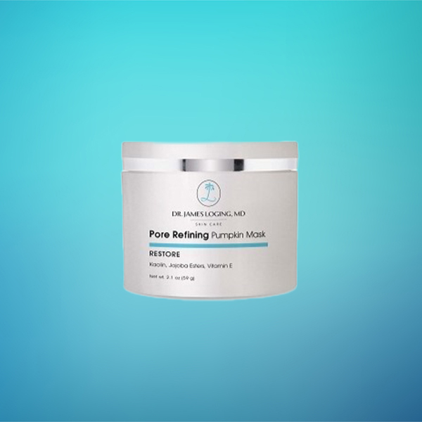 White jar of pore-refining pumpkin mask skincare product labeled RESTORE on turquoise gradient background